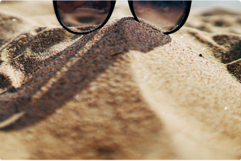Mound of sand with sunglasses on top