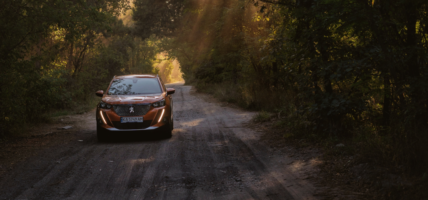 Interactive Finance Product Tool Orange Peugeot driving on a dark road