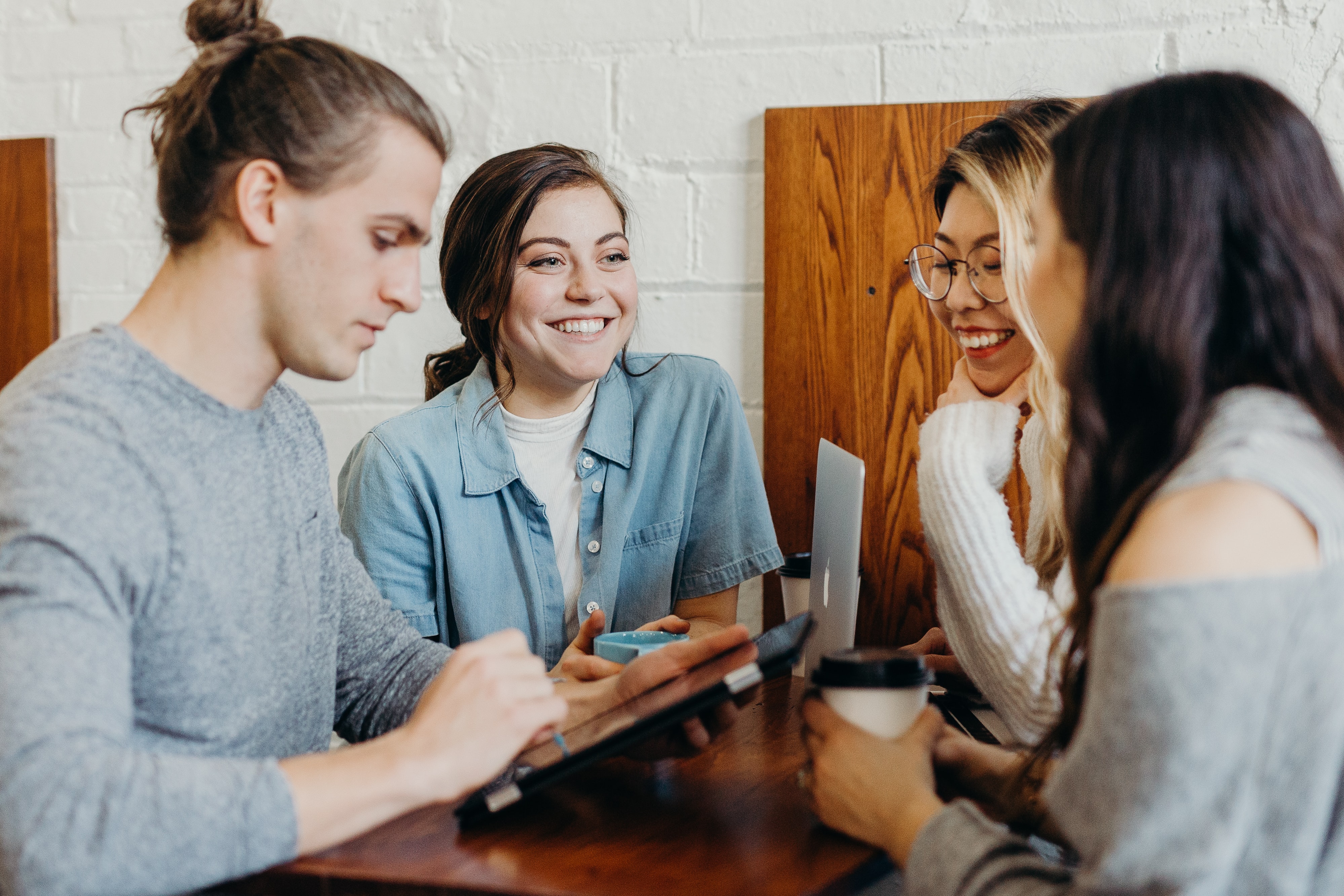 A young group smiling together whilst working