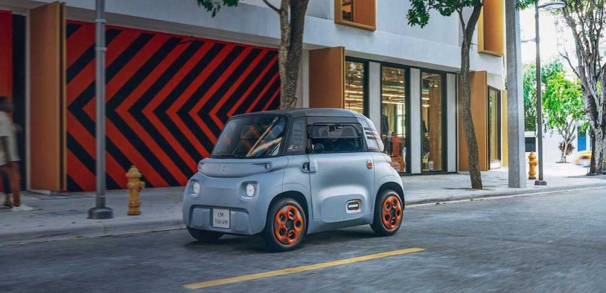 Citroen Ami driving down an urban road