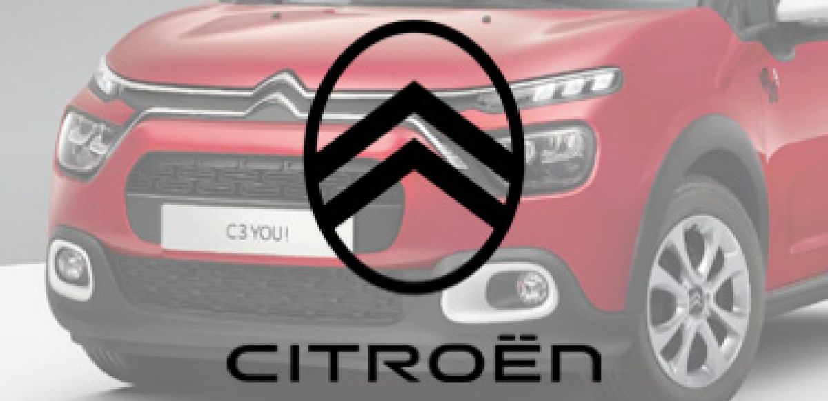 Greyscale Citroen logo with car in background