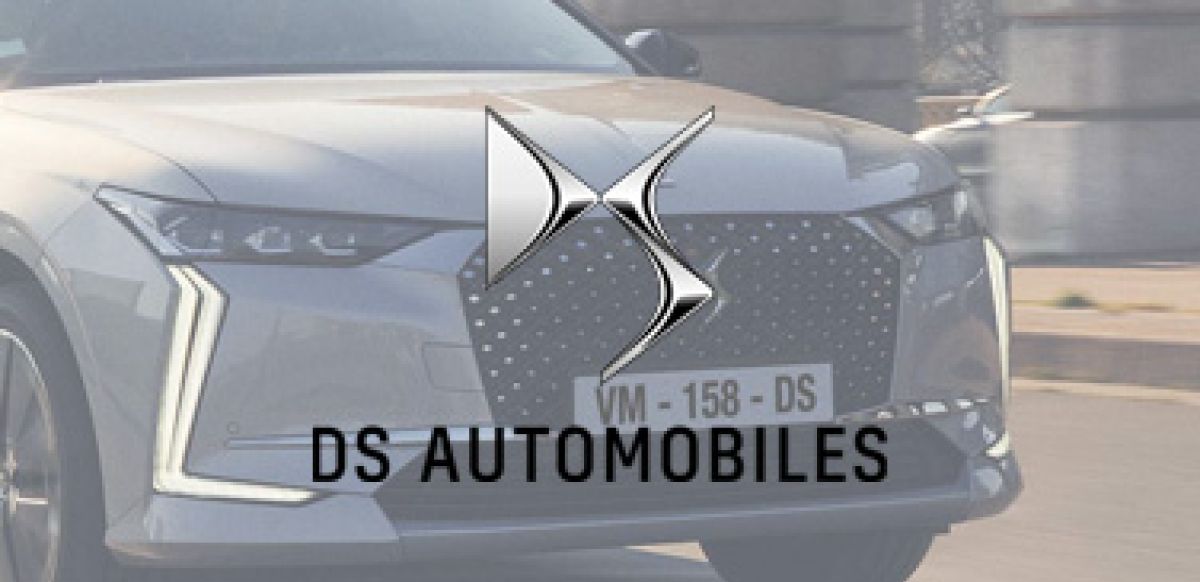 Greyscale DS logo with car in background
