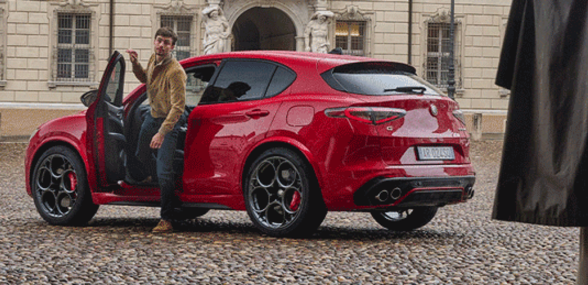 Man getting out of a Red Alfa Romeo Stelvio