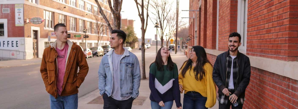Group of young people walking down road