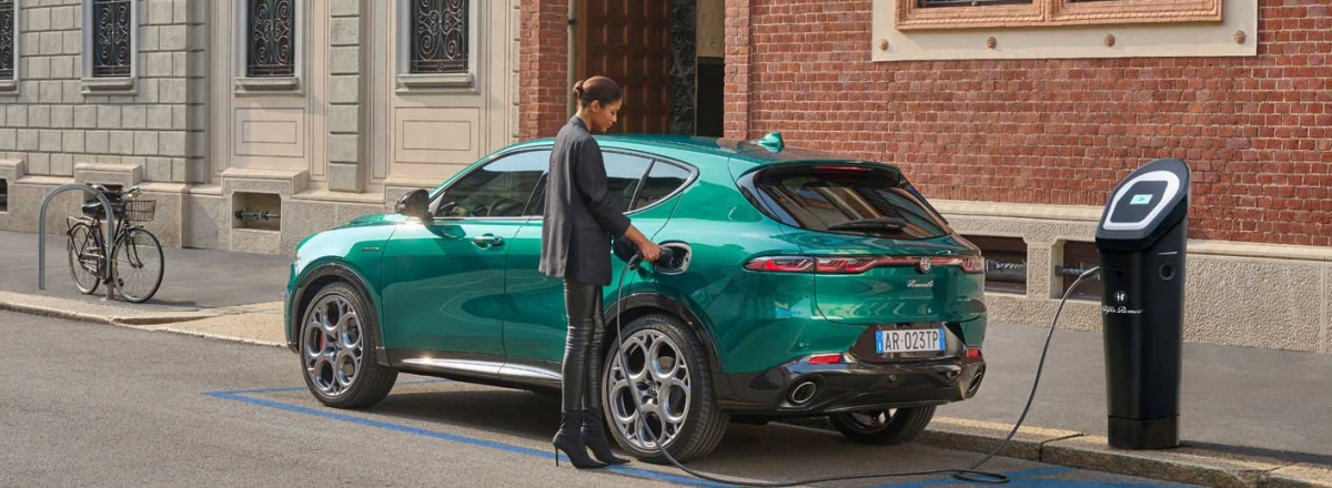 Hybrid Alfa Romeo being charged on the street