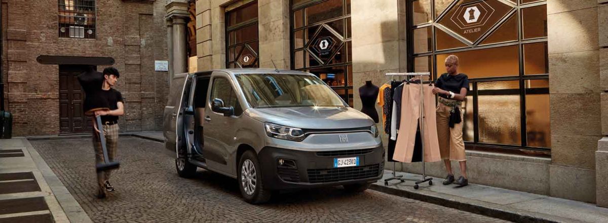 Maestro Grey Fiat Doblo with men loading a clothing rack