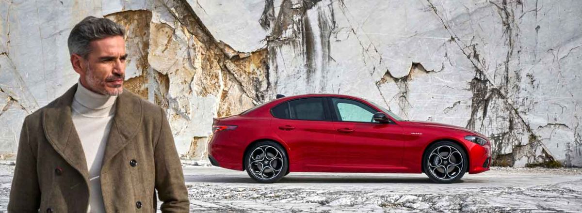 Man walking away from red Alfa Romeo Stelvio