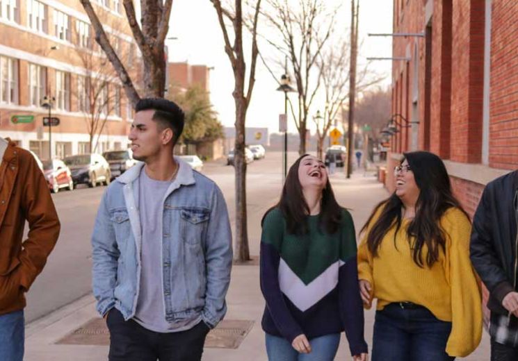 Group of young people walking down road