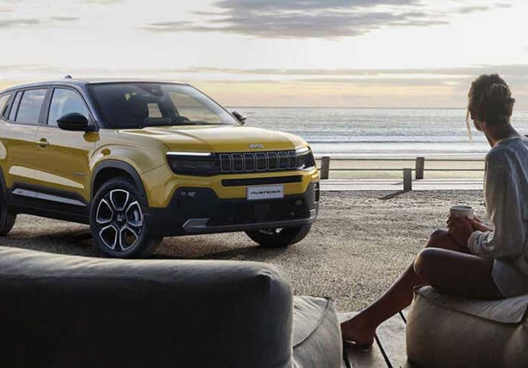 lady sitting on beach with jeep
