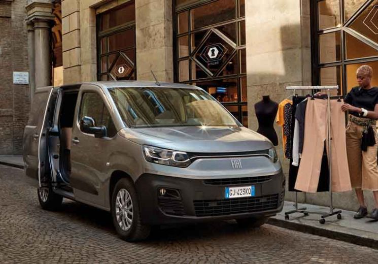 Maestro Grey Fiat Doblo with men loading a clothing rack