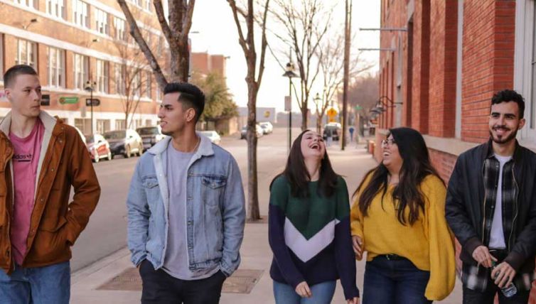 Group of young people walking down road
