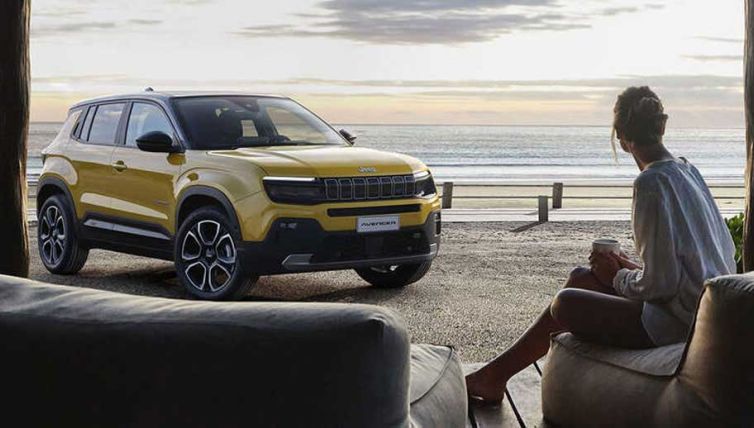 lady sitting on beach with jeep