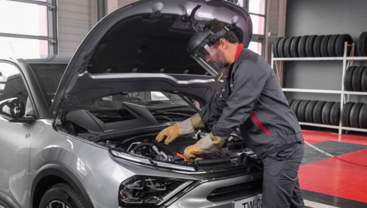 Approved technician servicing vehicle