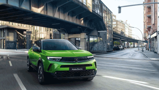 Green Vauxhall Mokka in a city road