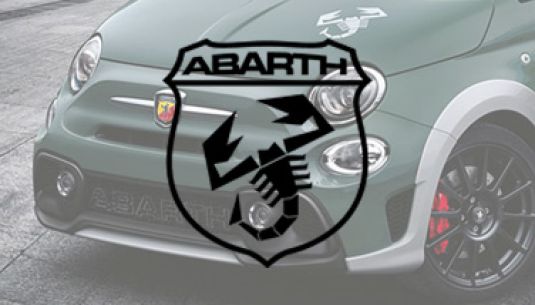 Greyscale Abarth logo with car in background