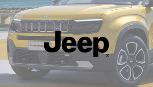 Greyscale Jeep logo with Jeep Avenger in the background