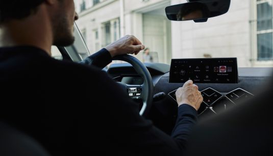 Man inside a NEW DS3 interacting with multimedia system