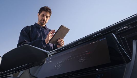 Technician completing inspection checks on a SPOTICAR vehicle