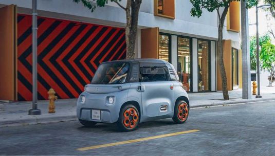 Citroen Ami driving down an urban road