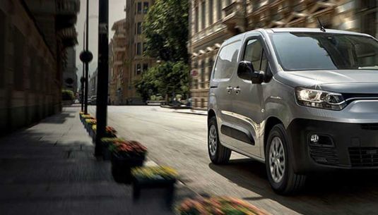 Fiat Doblo in silver driving through city