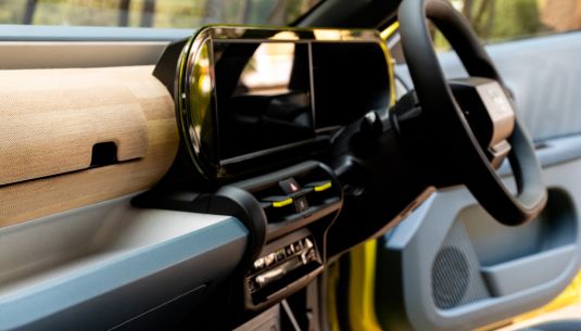 Interior of a Fiat Grande Panda with a digital display and steering wheel.