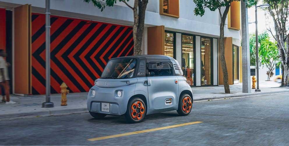 Citroen Ami driving down an urban road