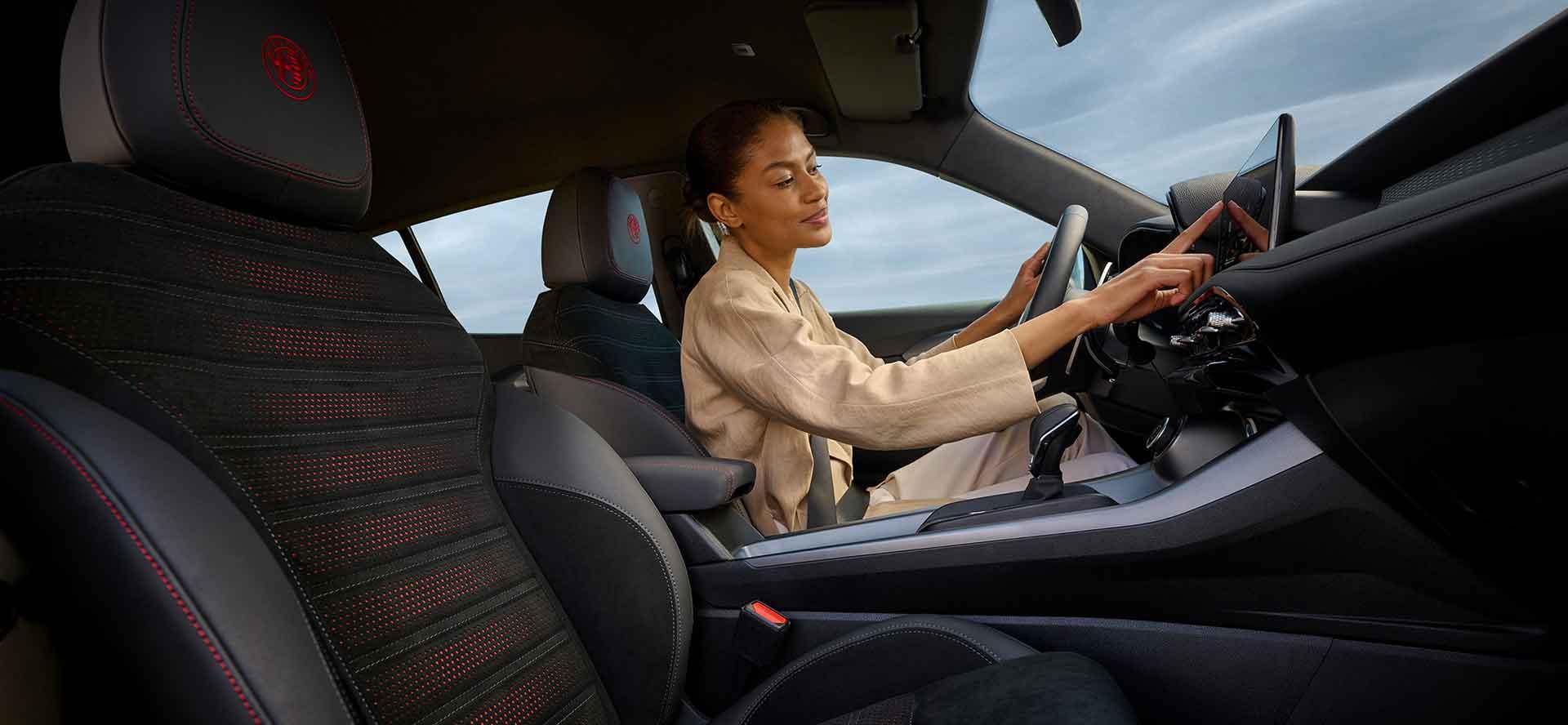 Alfa Romeo tonale lady inside car pressing the entertainment system