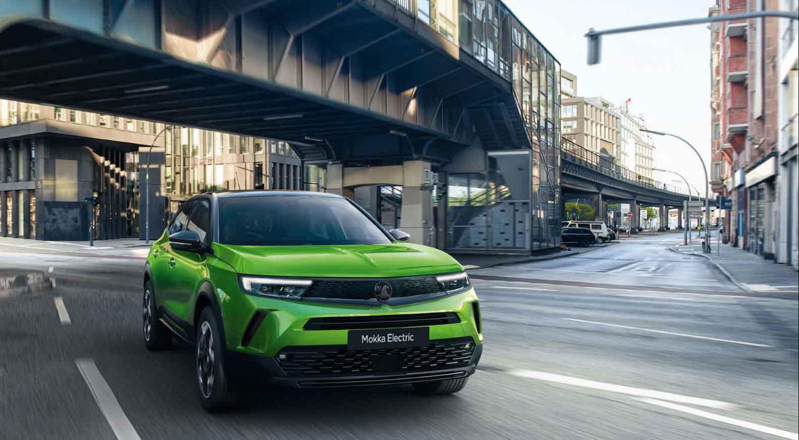 Green Vauxhall Mokka in a city road