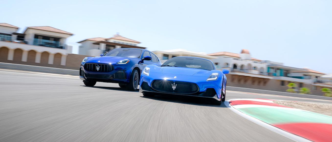 Two blue Maserati's on a race track